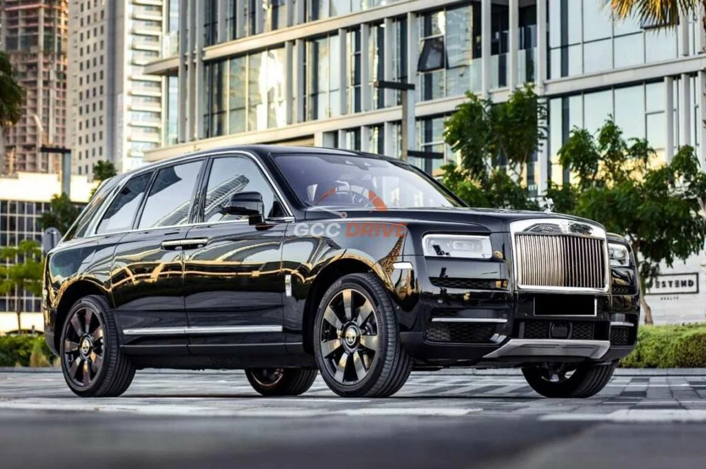 Black Rolls-Royce Cullinan luxury SUV parked in a modern city setting, representing Rolls Royce rental Dubai with chauffeur.