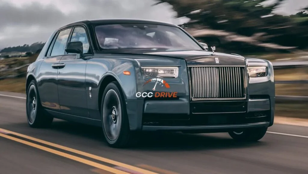 Rolls-Royce Phantom luxury sedan driving on a road, representing a Rolls Royce Phantom with chauffeur service available in Dubai.